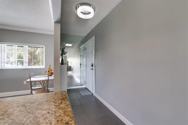 a view of a hallway with wooden floor and a workspace