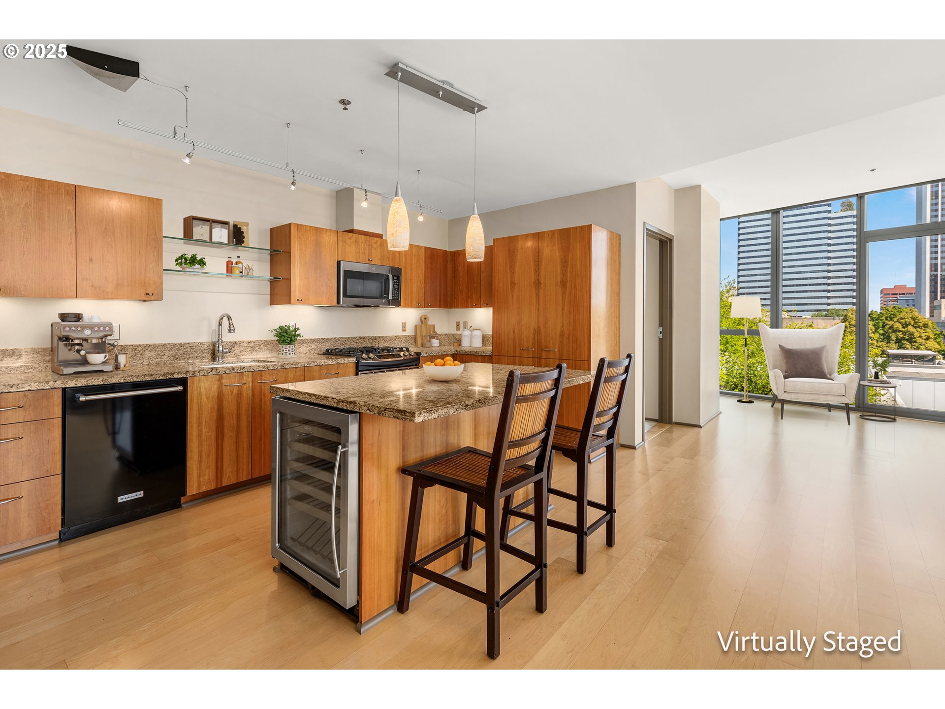 1221 Southwest 10th Avenue, Unit 505 Portland, OR 97205 - Photo 16 of 41 a kitchen with stainless steel appliances granite countertop a stove top oven a sink a dining table and chairs with wooden floor