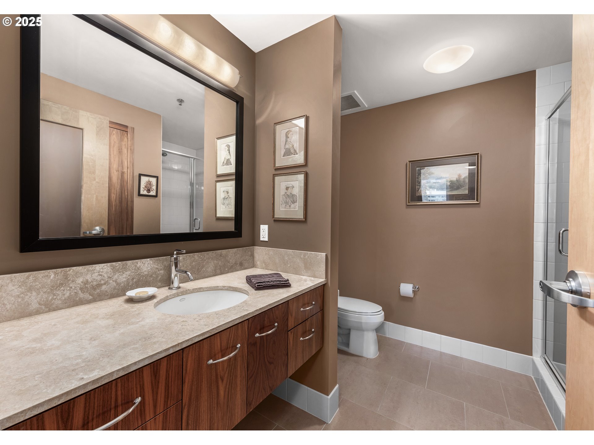 1221 Southwest 10th Avenue, Unit 505 Portland, OR 97205 - Photo 28 of 41 a bathroom with a granite countertop sink toilet and mirror
