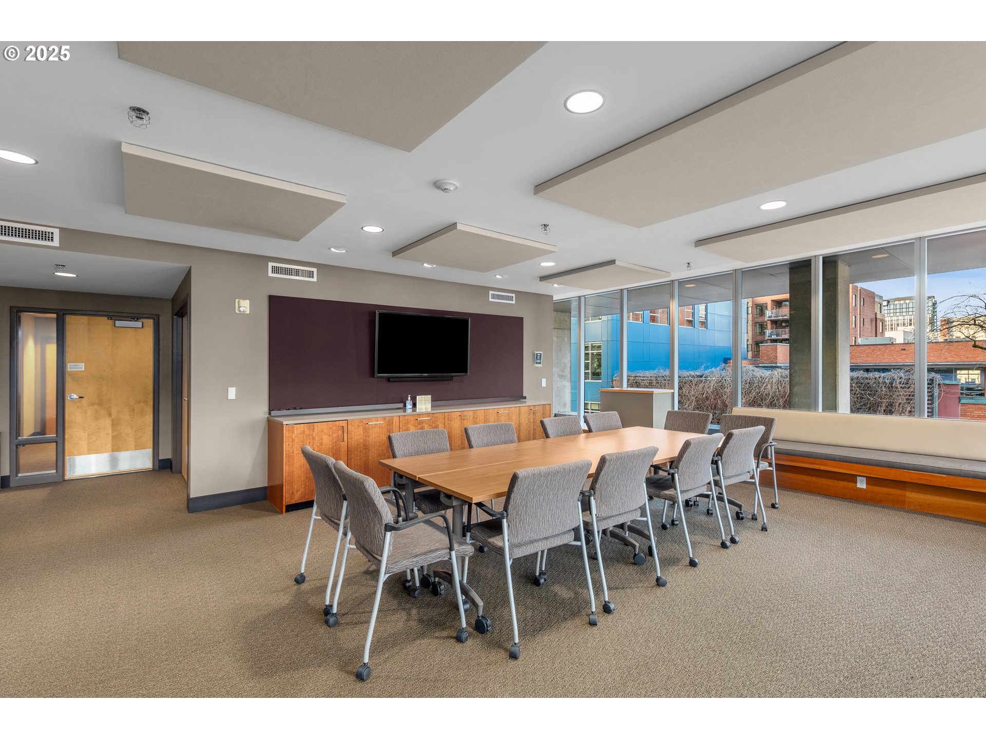 1221 Southwest 10th Avenue, Unit 505 Portland, OR 97205 - Photo 35 of 41 a view of a dining room with furniture wooden floor and a flat screen tv