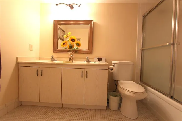 a bathroom with a sink a toilet and mirror