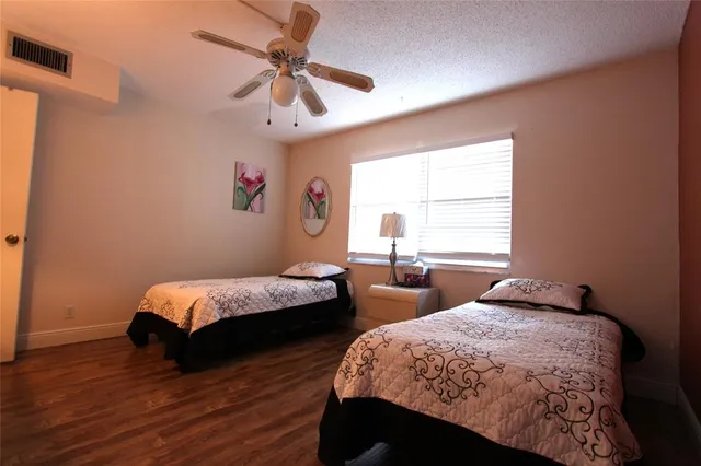 a bedroom with two beds and a window