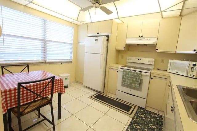 a kitchen with stainless steel appliances a stove a refrigerator and cabinets