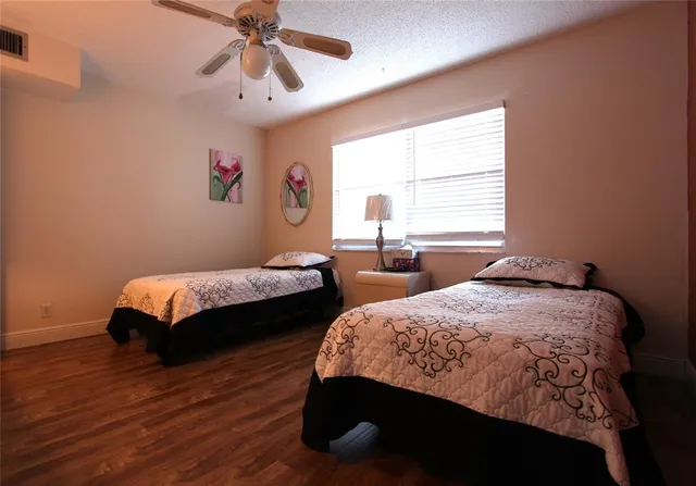 a bedroom with two beds and a chandelier