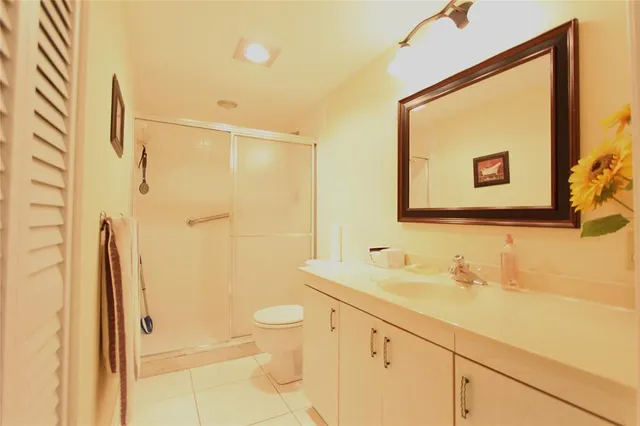 a bathroom with a shower sink and a mirror