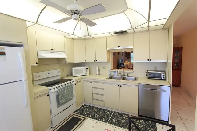 a kitchen with a sink cabinets and window