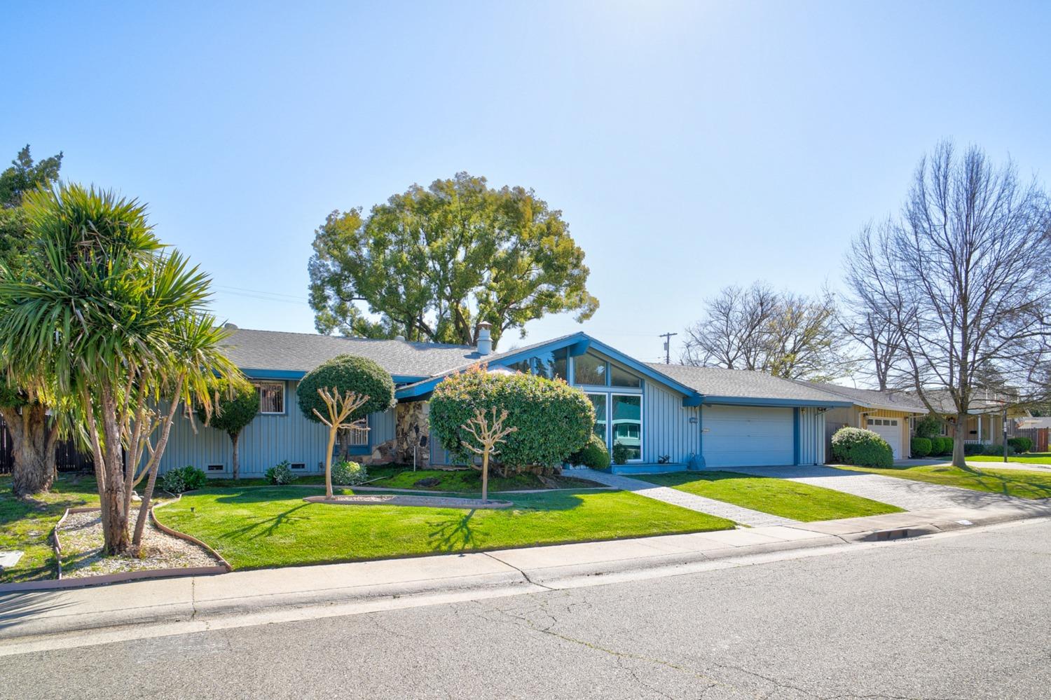 a view of a house with a swimming pool and a yard