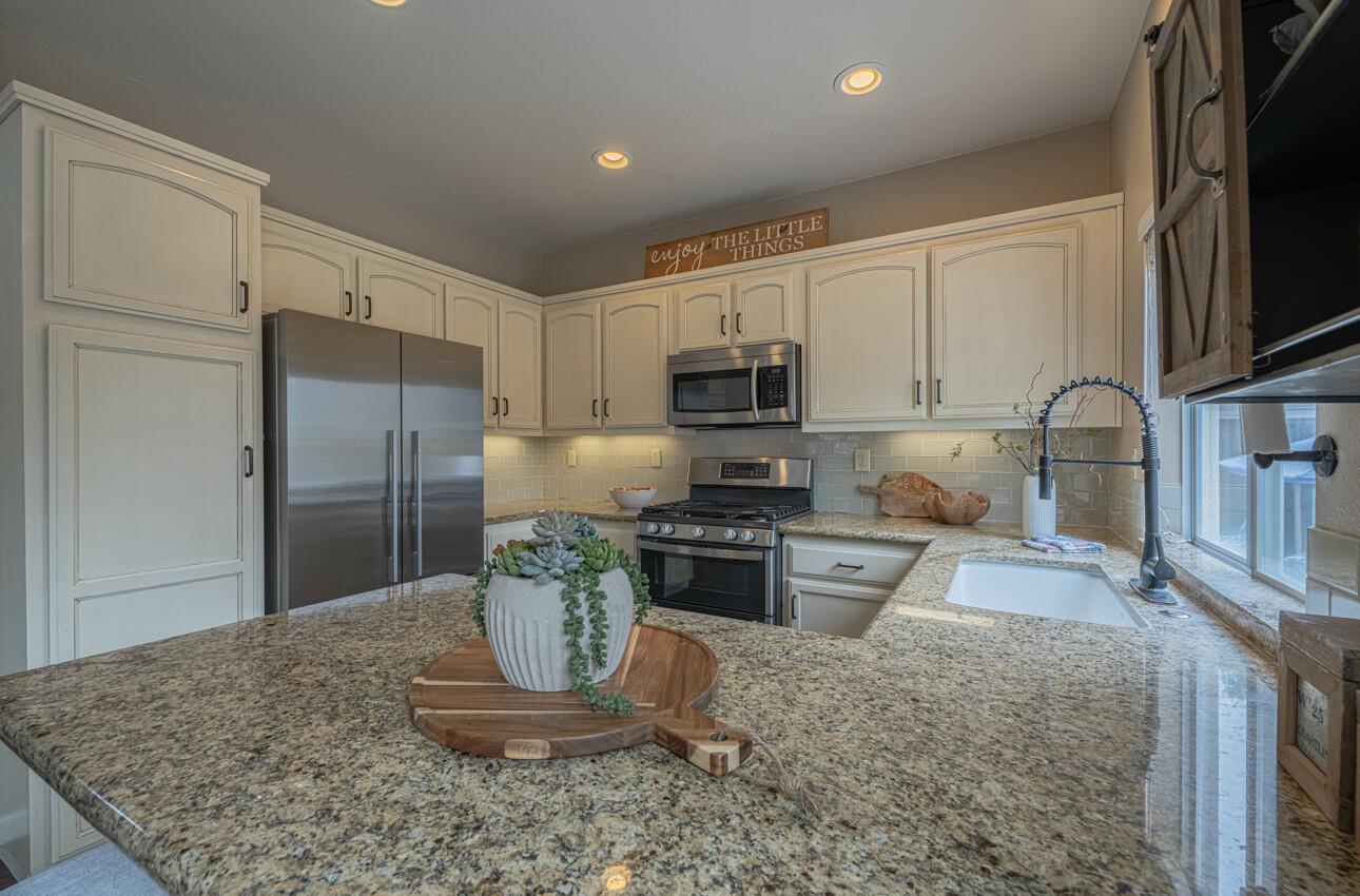 18106 Stonehaven Salinas, CA 93908 - Photo 13 of 39 a kitchen with stainless steel appliances granite countertop a refrigerator a stove top oven a sink and dishwasher