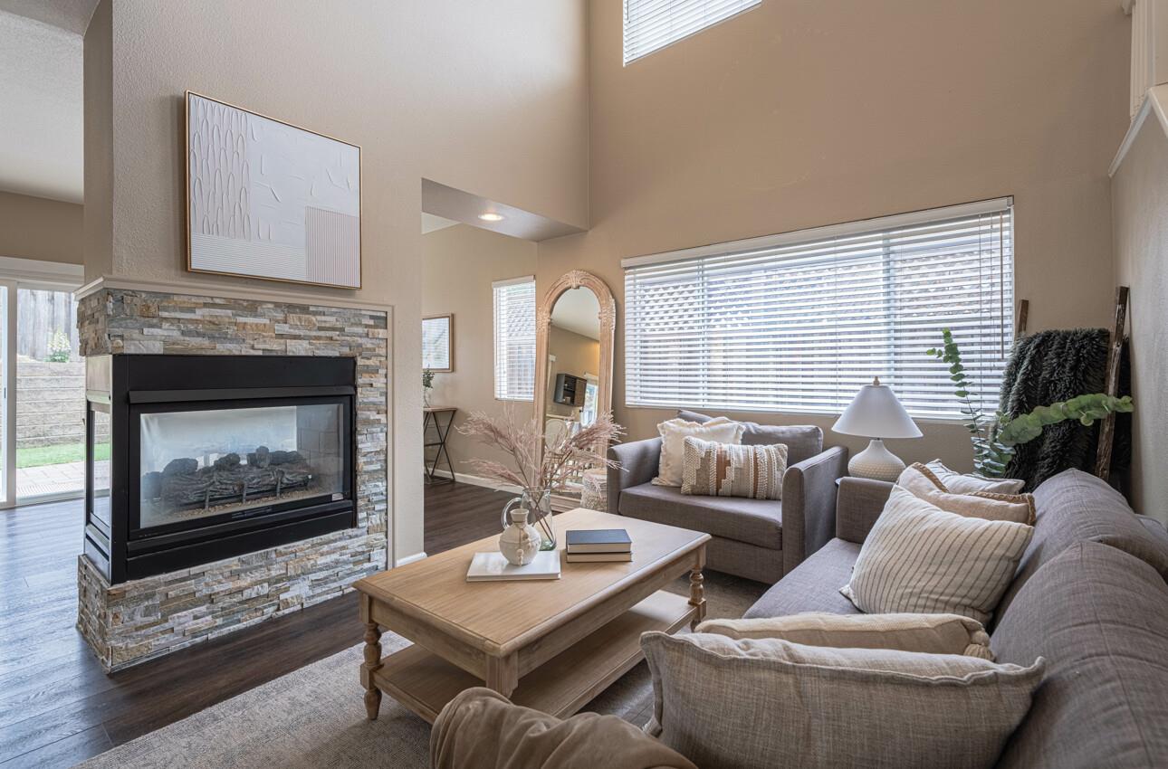 18106 Stonehaven Salinas, CA 93908 - Photo 8 of 39 a living room with furniture a fireplace a lamp and a large window