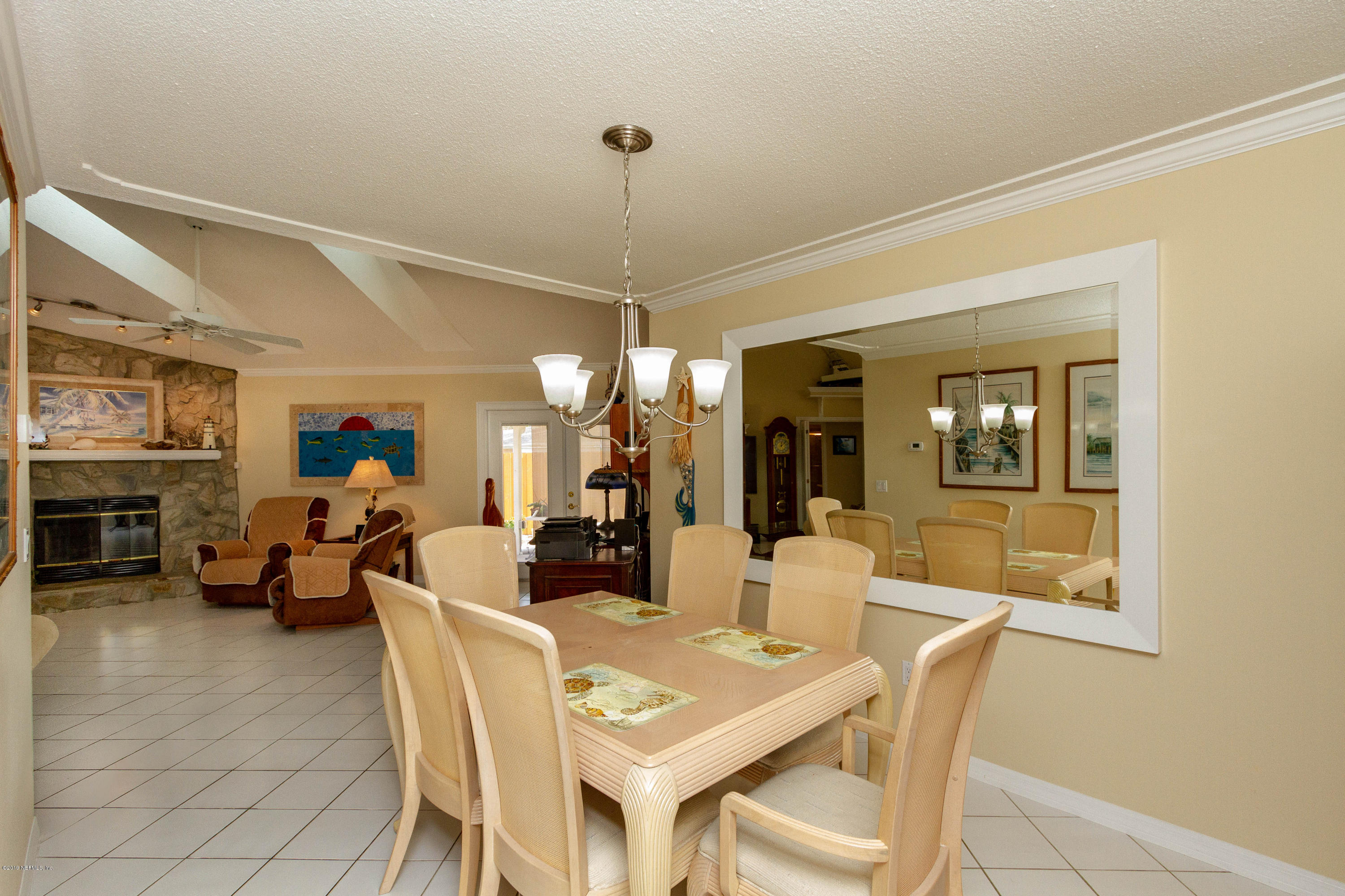 367 Shamrock Road St. Augustine, FL 32086 - Photo 14 of 58 a living room with furniture a chandelier and a large window