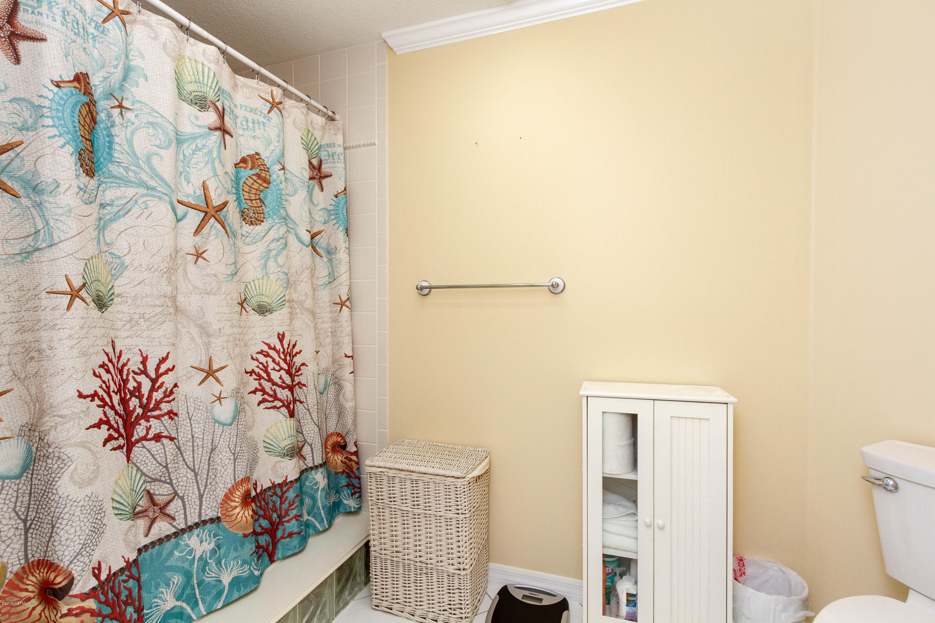 367 Shamrock Road St. Augustine, FL 32086 - Photo 20 of 58 a bathroom with a toilet and a shower curtain