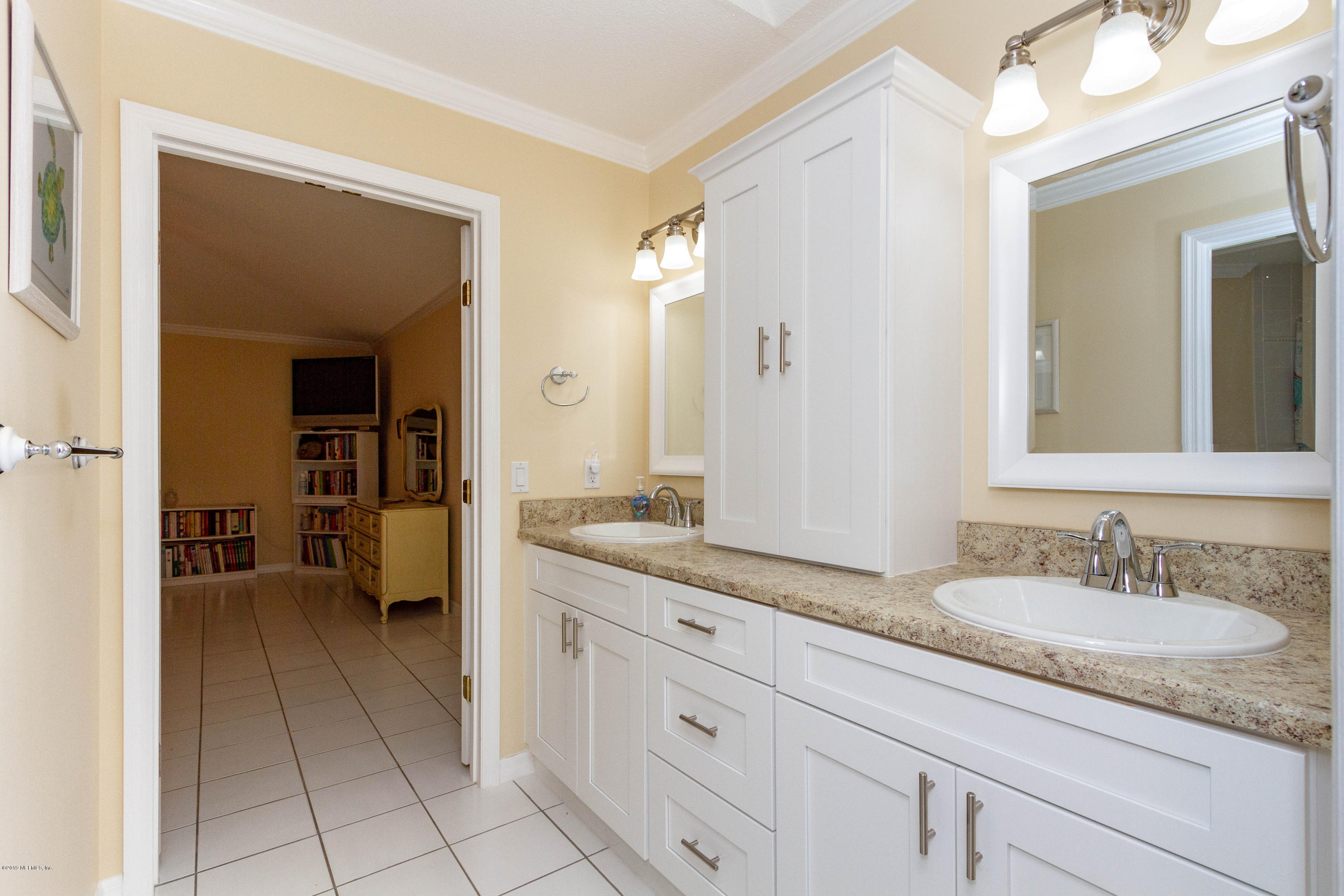367 Shamrock Road St. Augustine, FL 32086 - Photo 21 of 58 a en suite bathroom with a granite countertop sink and a mirror