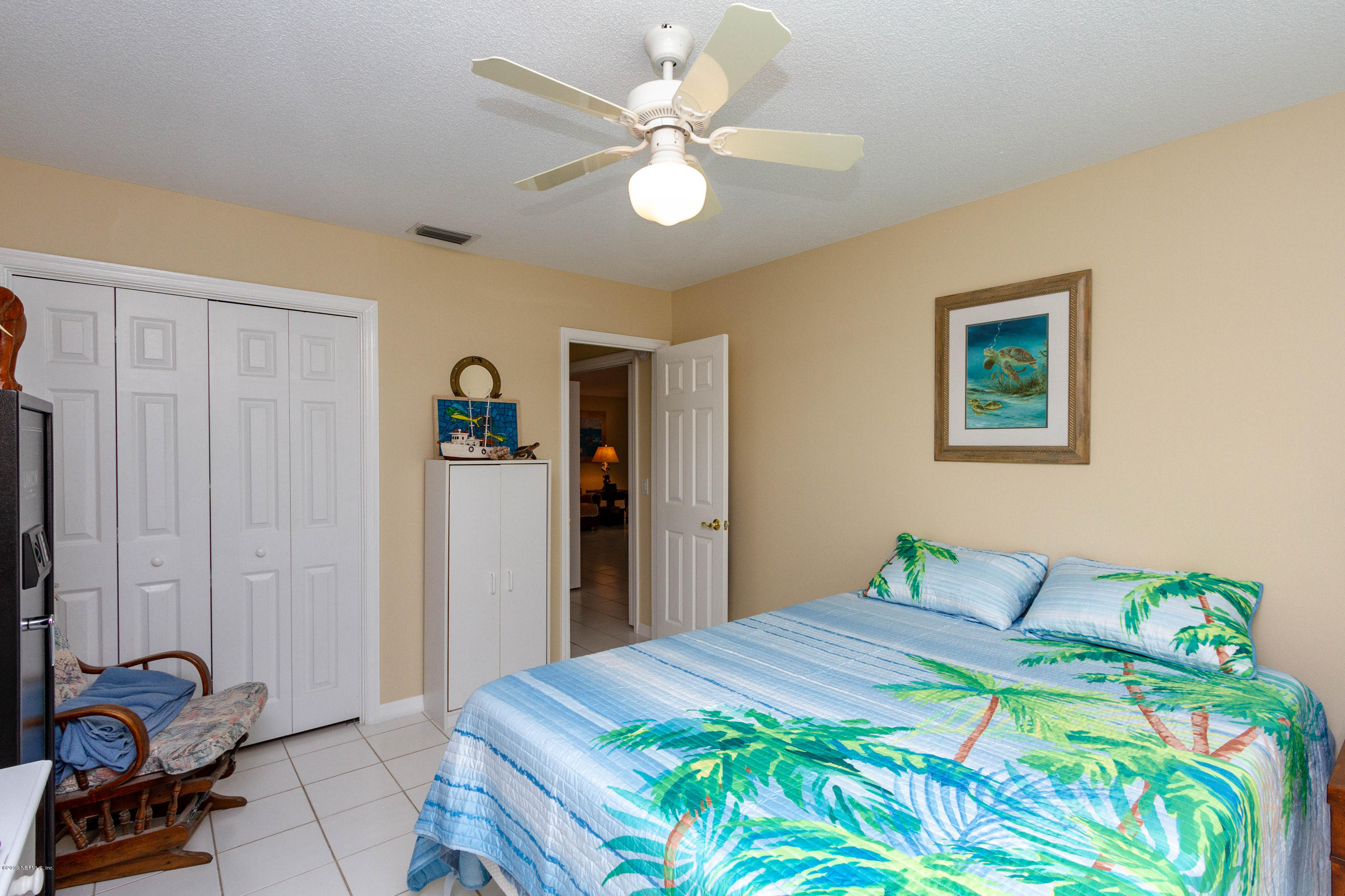 367 Shamrock Road St. Augustine, FL 32086 - Photo 23 of 58 a bedroom with a bed and a chandelier