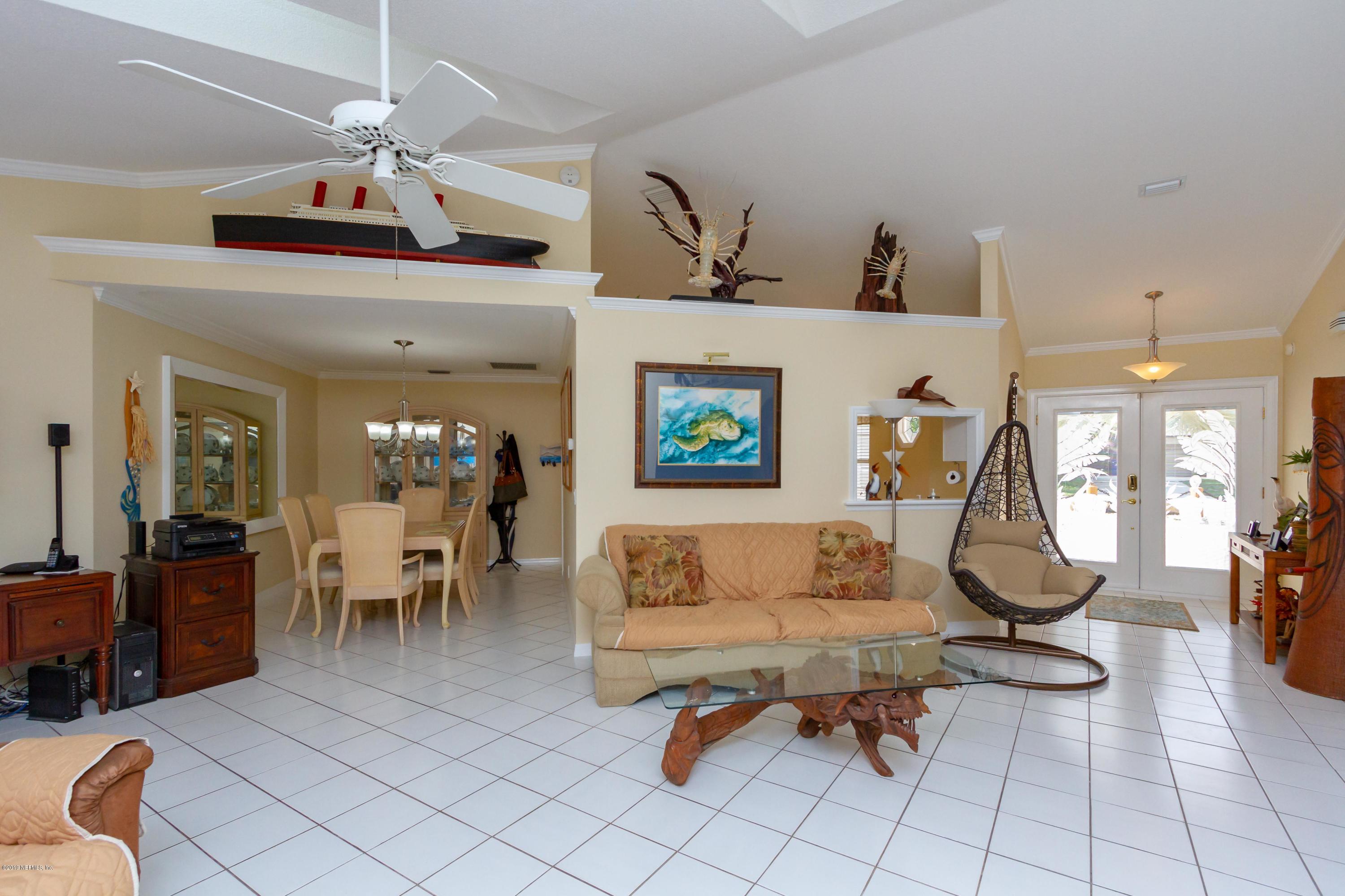 367 Shamrock Road St. Augustine, FL 32086 - Photo 7 of 58 a living room with furniture gym equipment and a chandelier