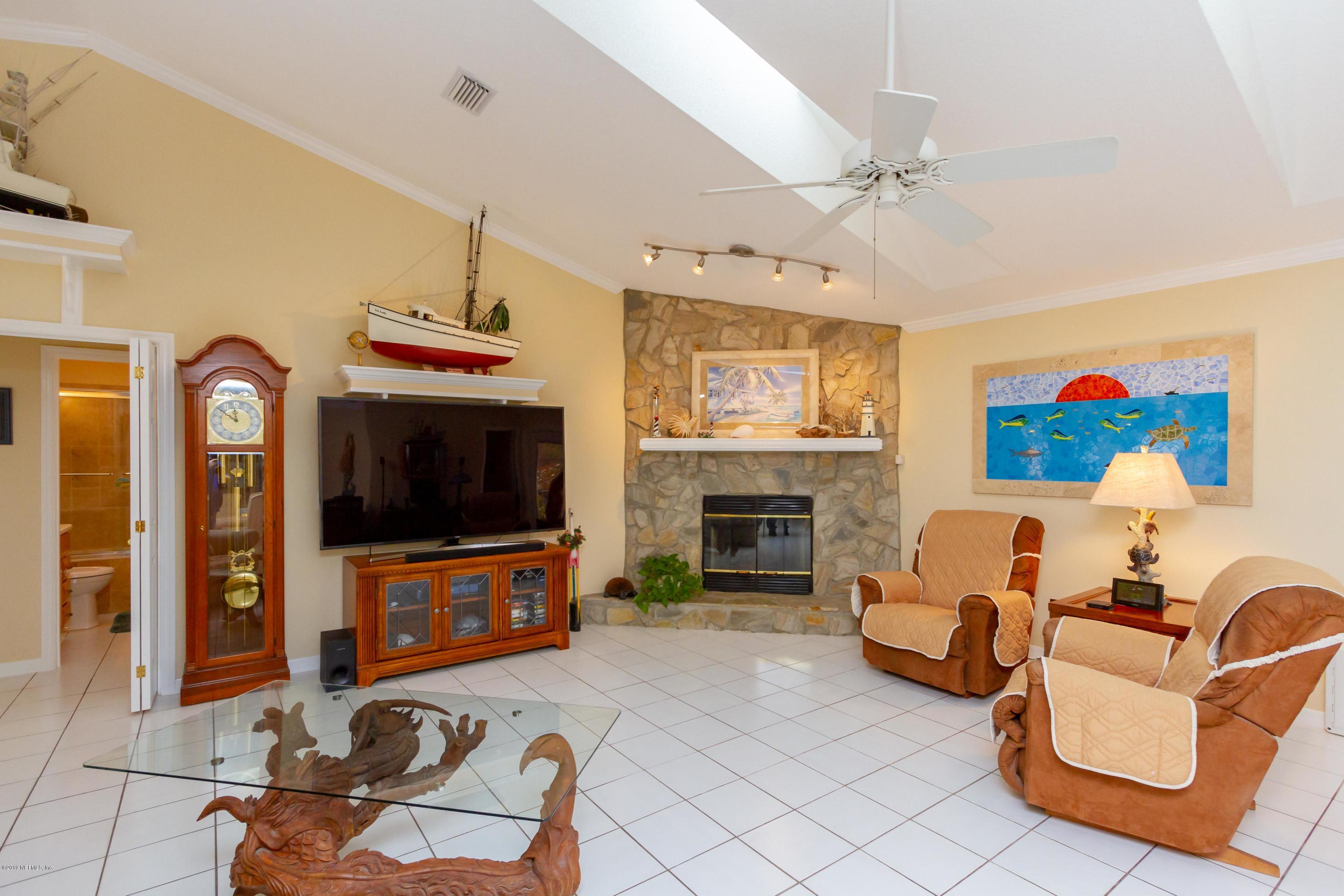 367 Shamrock Road St. Augustine, FL 32086 - Photo 8 of 58 a living room with furniture a flat screen tv and a fireplace