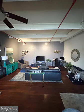 a living room with lots of furniture and kitchen view