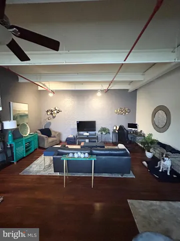 a living room with lots of furniture and kitchen view