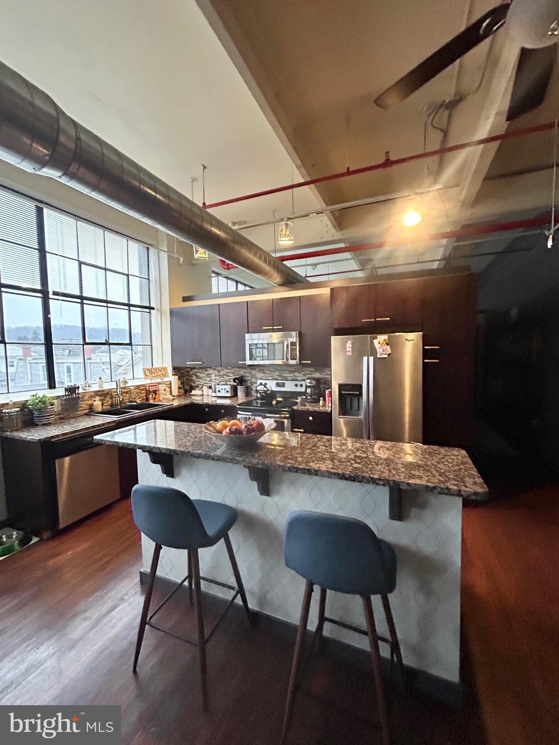 31 South Sterley Street, Unit 401 Reading, PA 19607 - Photo 5 of 12 a kitchen with a table and chairs in it