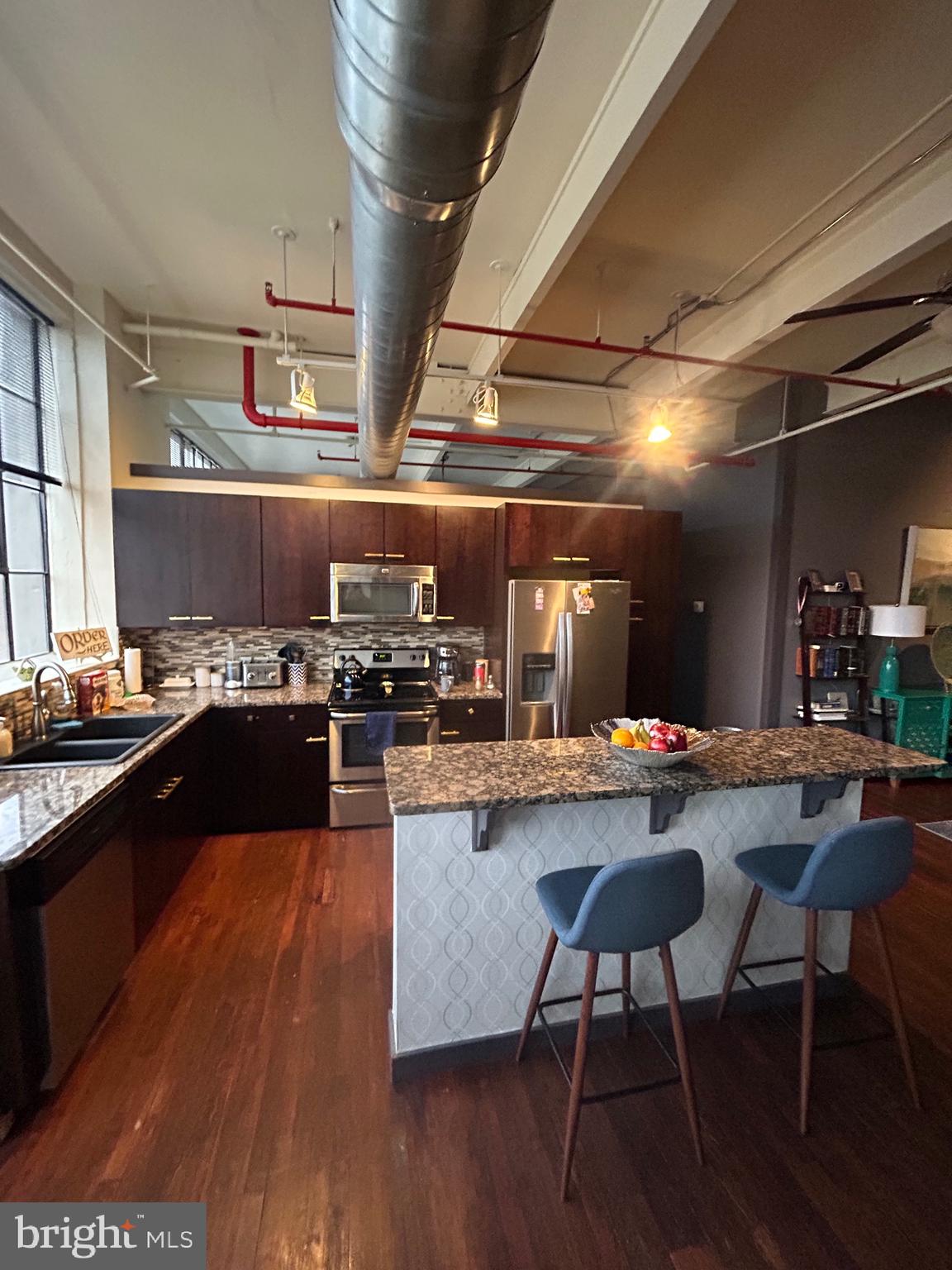 31 South Sterley Street, Unit 401 Reading, PA 19607 - Photo 6 of 12 a kitchen with a table chairs and wooden floor