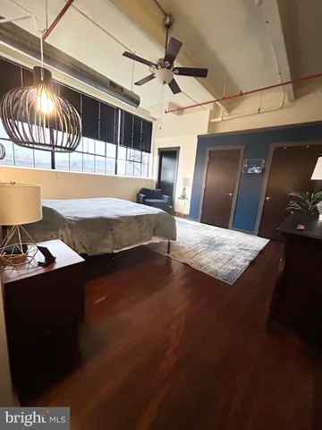 a bedroom with a bed and a large window