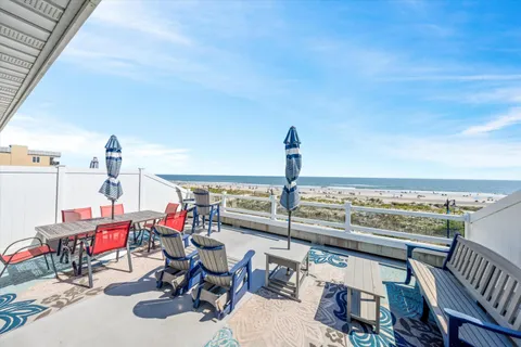 a view of a chairs and table in the balcony