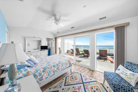 a bedroom with a bed and glass walk in closet