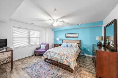 a spacious bathroom with a granite countertop sink a toilet and a large mirror