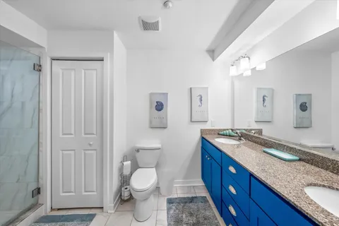 a bedroom with beds and a chandelier