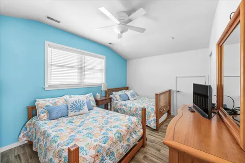 a bathroom with a granite countertop sink a toilet and a mirror