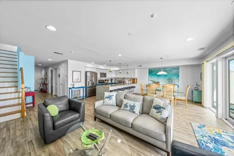 a dining room with furniture a chandelier and wooden floor