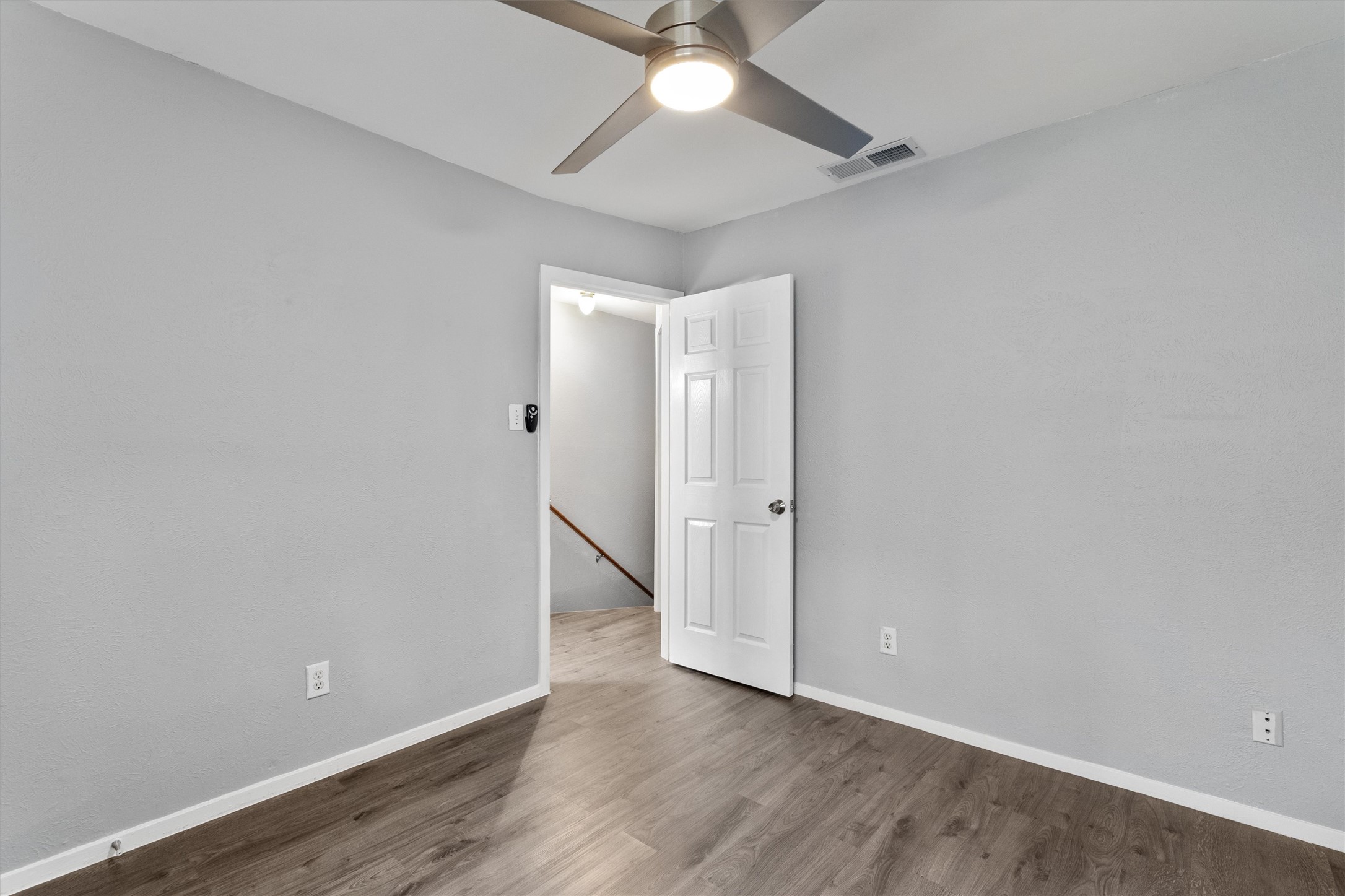 3415 Menchaca Road, Unit 113 Austin, TX 78704 - Photo 16 of 21 an empty room with wooden floor and ceiling fan