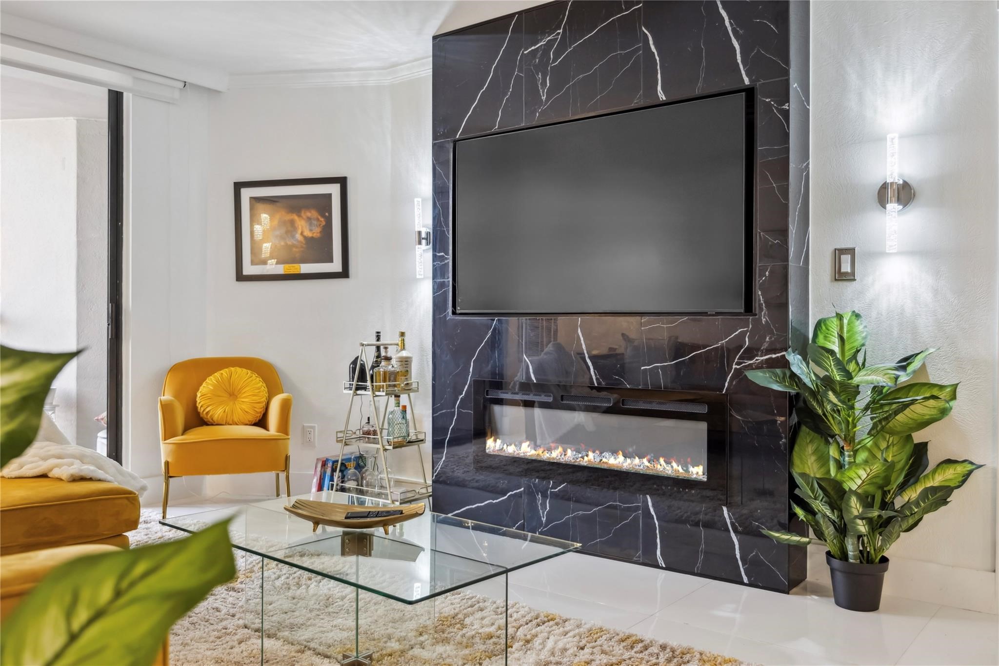3525 Sage Road, Unit 1713 Houston, TX 77056 - Photo 3 of 25 Sophisticated living space featuring a striking black marble media wall with electric fireplace and mounted TV, complemented by sleek porcelain floors and designer accents. Perfect for relaxing or entertaining—schedule your private showing today!