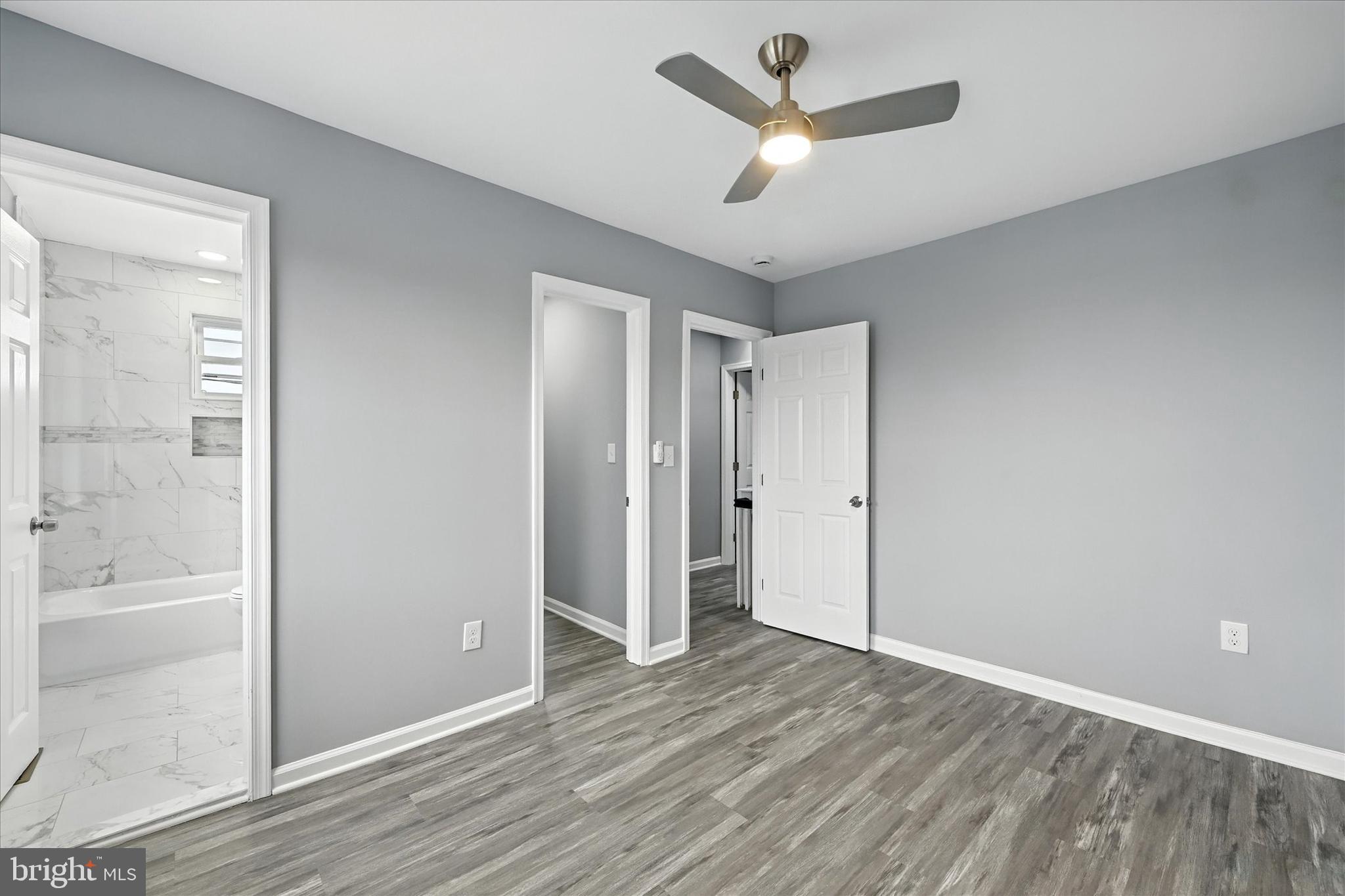 1118 Weldon Avenue Baltimore, MD 21211 - Photo 16 of 27 a view of a livingroom with a ceiling fan wooden floor and window