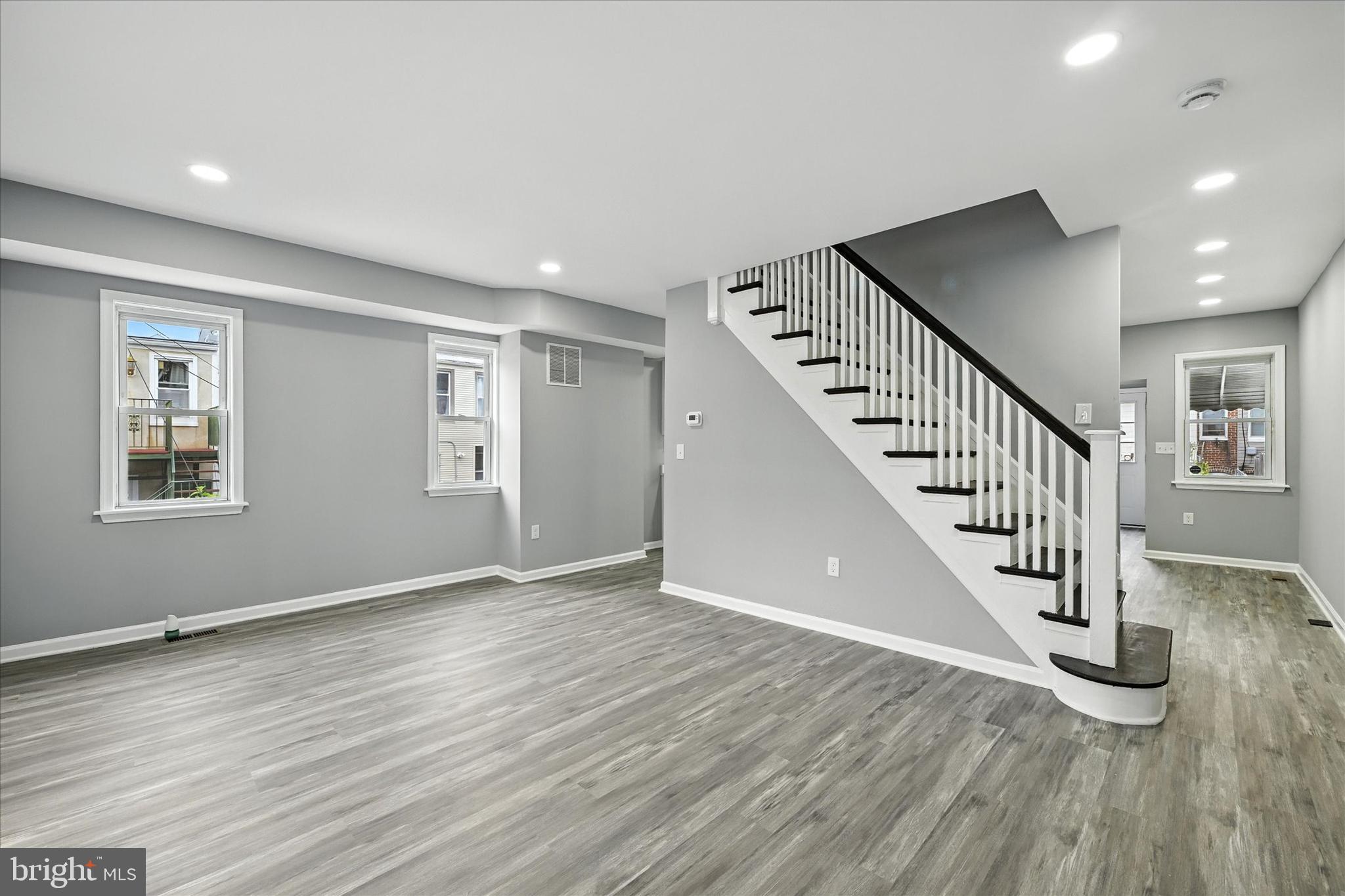 1118 Weldon Avenue Baltimore, MD 21211 - Photo 3 of 27 a view of an empty room with wooden floor and stairs