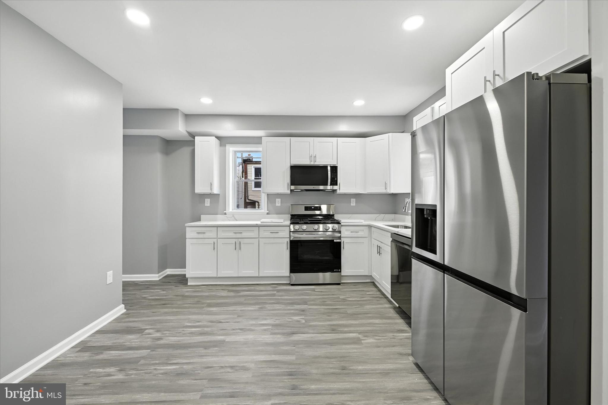 1118 Weldon Avenue Baltimore, MD 21211 - Photo 9 of 27 a kitchen with a refrigerator stove and sink
