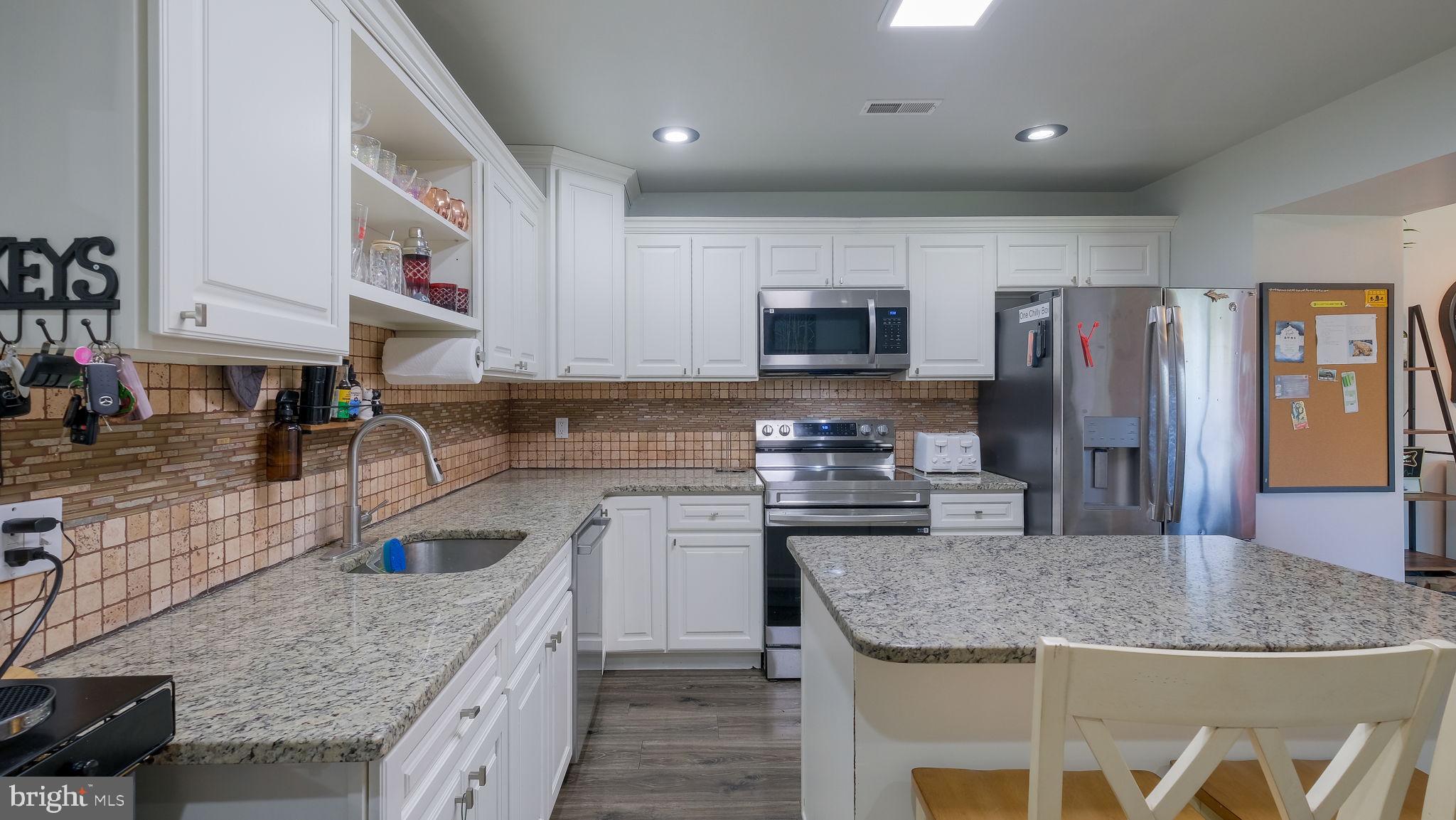 1706 Susan Avenue Croydon, PA 19021 - Photo 12 of 26 a kitchen with stainless steel appliances granite countertop a sink refrigerator and microwave