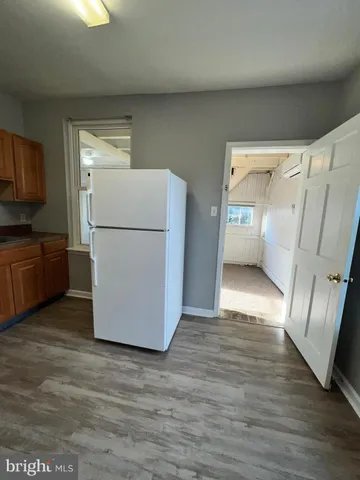 a kitchen with granite countertop wood cabinets and a stove