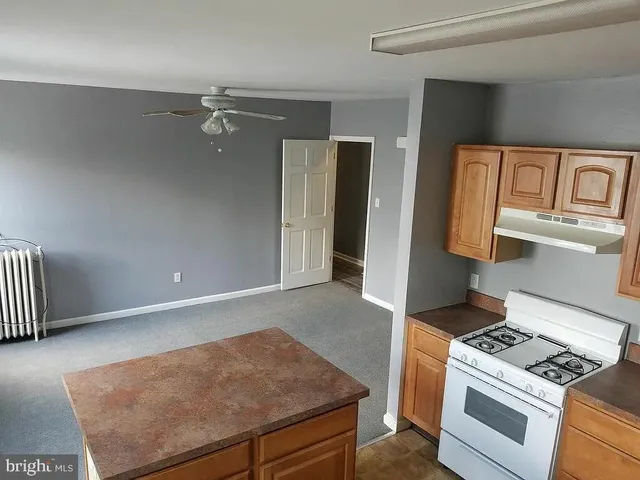 a view of a kitchen with a sink and dishwasher with wooden floor