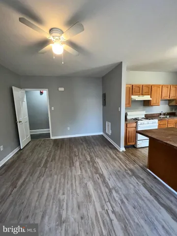 a kitchen with stainless steel appliances granite countertop a refrigerator and a stove