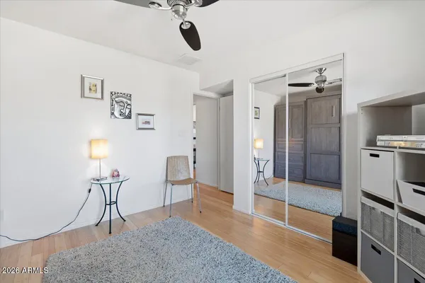 a bedroom with a bed and a refrigerator