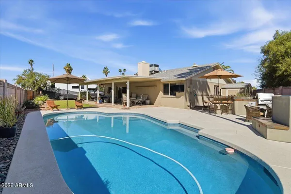 a view of a swimming pool with a patio