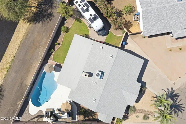 a view of a house with swimming pool and sitting area
