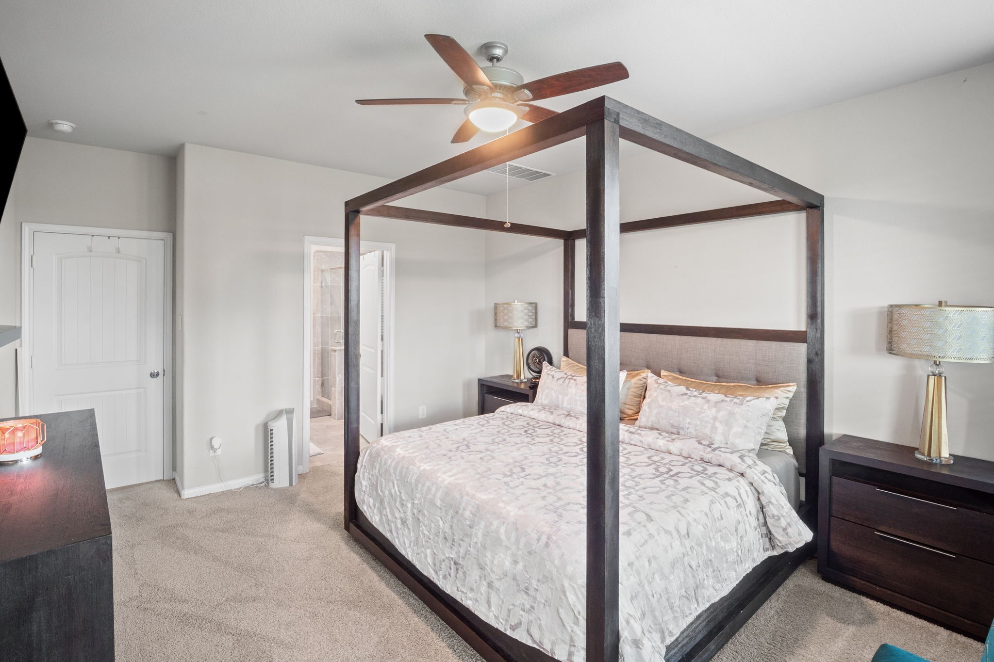 82 Indian Wells Drive Manvel, TX 77578 - Photo 12 of 30 a bedroom with a large bed and a chandelier