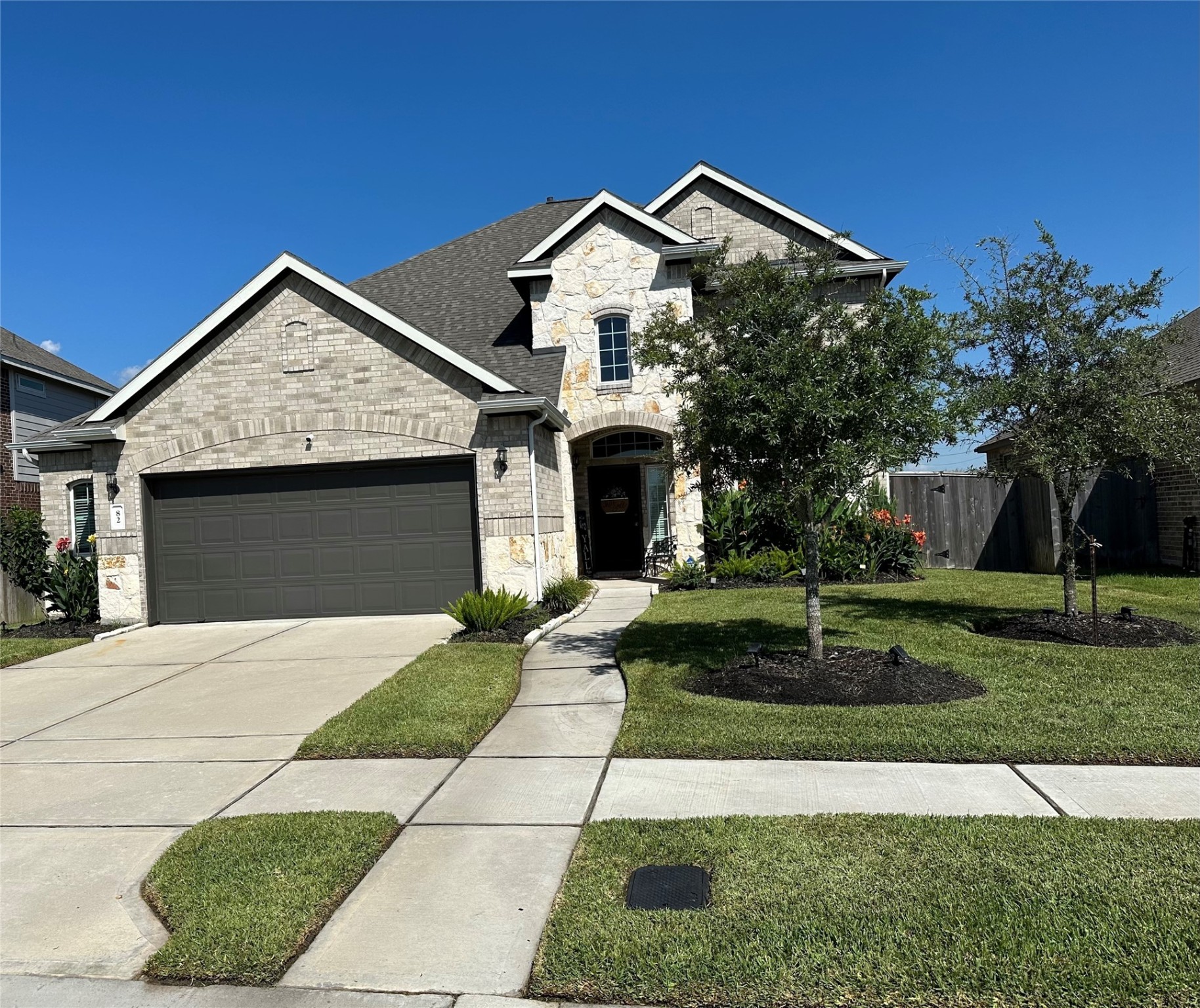 82 Indian Wells Drive Manvel, TX 77578 - Photo 2 of 30 a front view of a house with a yard and garage
