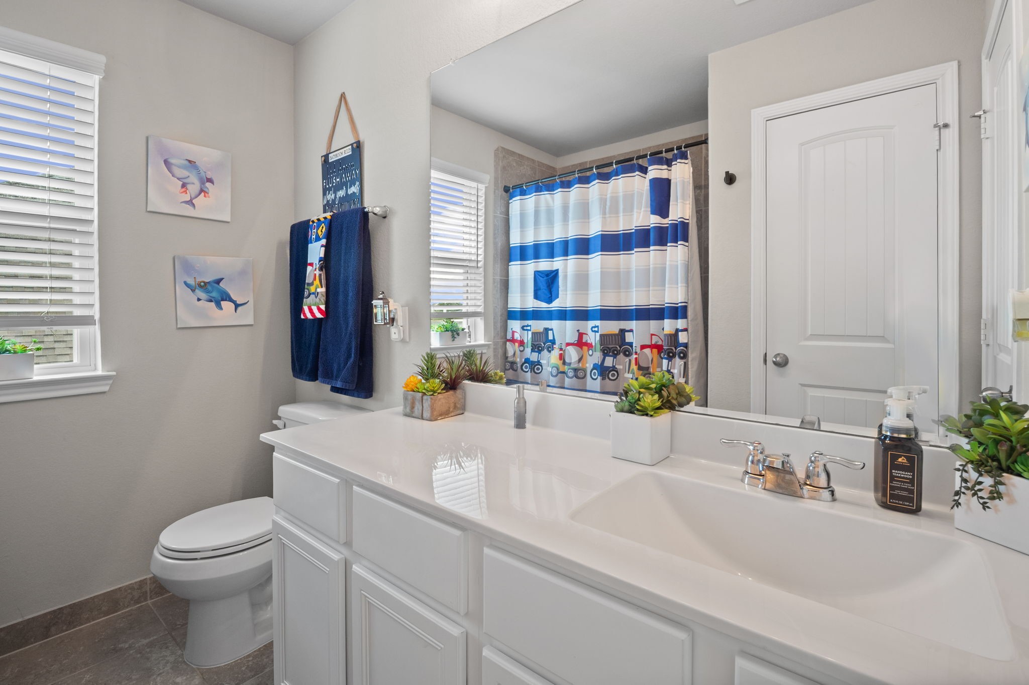 82 Indian Wells Drive Manvel, TX 77578 - Photo 22 of 30 a bathroom with a sink a toilet and a shower curtain