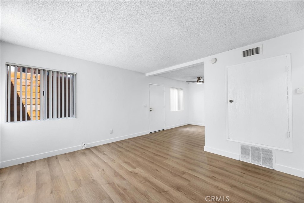 223 Shell Street Manhattan Beach, CA 90266 - Photo 12 of 50 a view of an empty room with wooden floor and a window