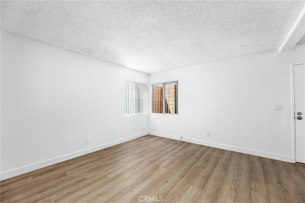 223 Shell Street Manhattan Beach, CA 90266 - Photo 13 of 50 an empty room with wooden floor and windows