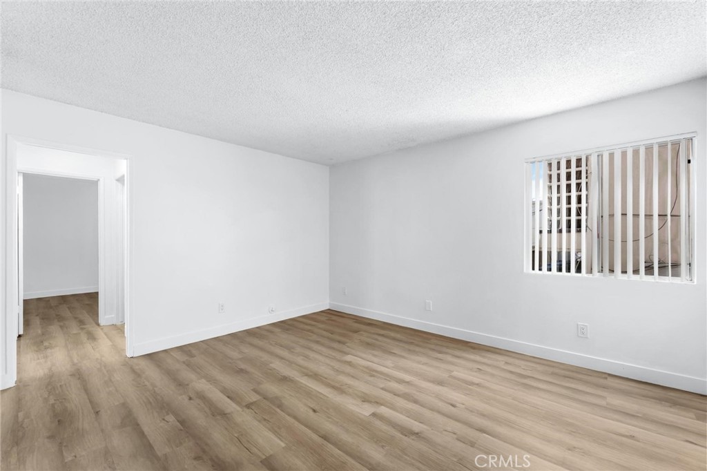 223 Shell Street Manhattan Beach, CA 90266 - Photo 14 of 50 a view of an empty room with wooden floor and a window