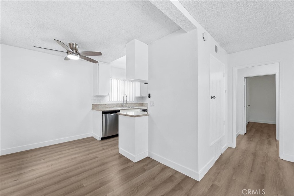 223 Shell Street Manhattan Beach, CA 90266 - Photo 15 of 50 a kitchen with kitchen island white cabinets and wooden floor