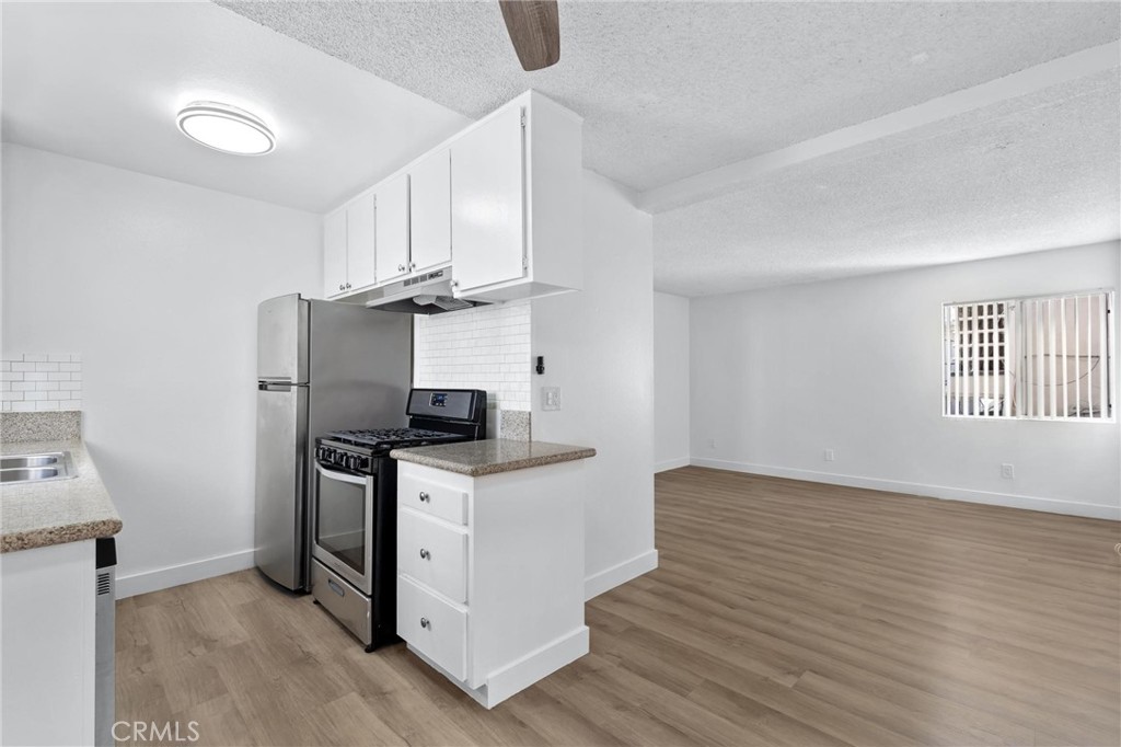 223 Shell Street Manhattan Beach, CA 90266 - Photo 17 of 50 a kitchen with granite countertop a stove and a sink